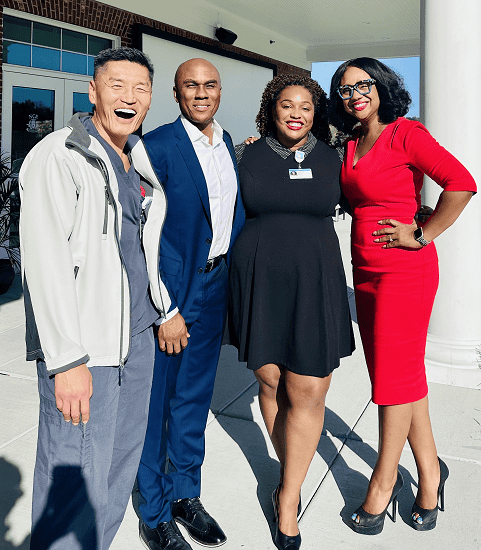 Four diverse healthcare professionals posing together at Kettering Health DEI symposium event.