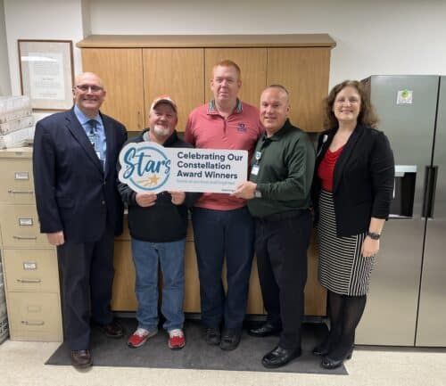 Five employees holding Constellation Award Winners sign celebrating healthcare team recognition