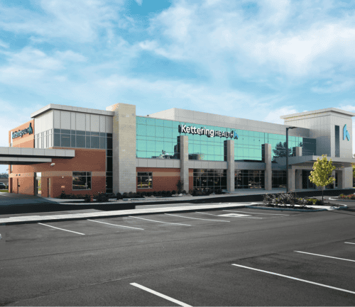 Modern Kettering Health medical facility with glass facade and parking lot in Wilmington
