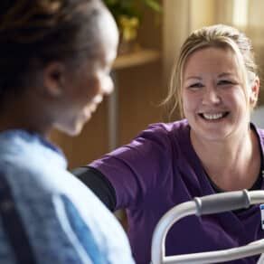 Kettering Health employee speaking with a patient and smiling