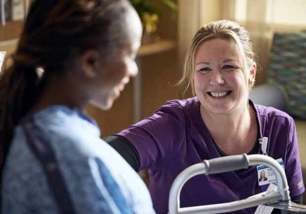 Kettering Health employee speaking with a patient and smiling