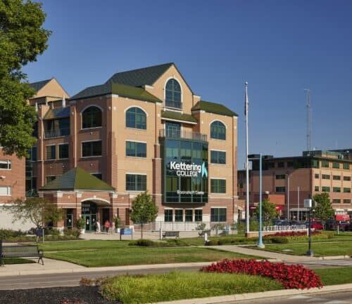 Kettering College Boonshoft Center brick building with green roof and landscaped campus grounds.