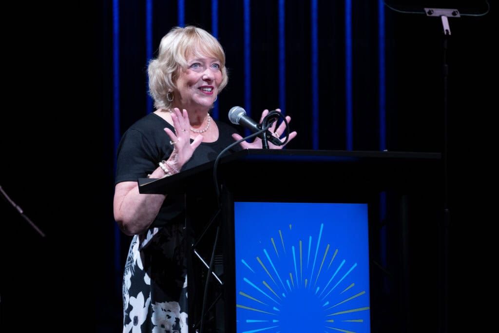 A woman speaking at a podium