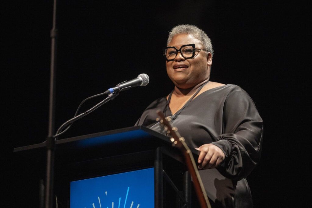 Brooke Harris speaking at a podium