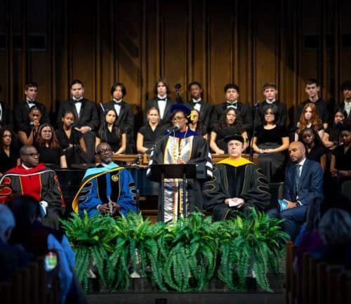 Dr. Mitchell speaking at a podium