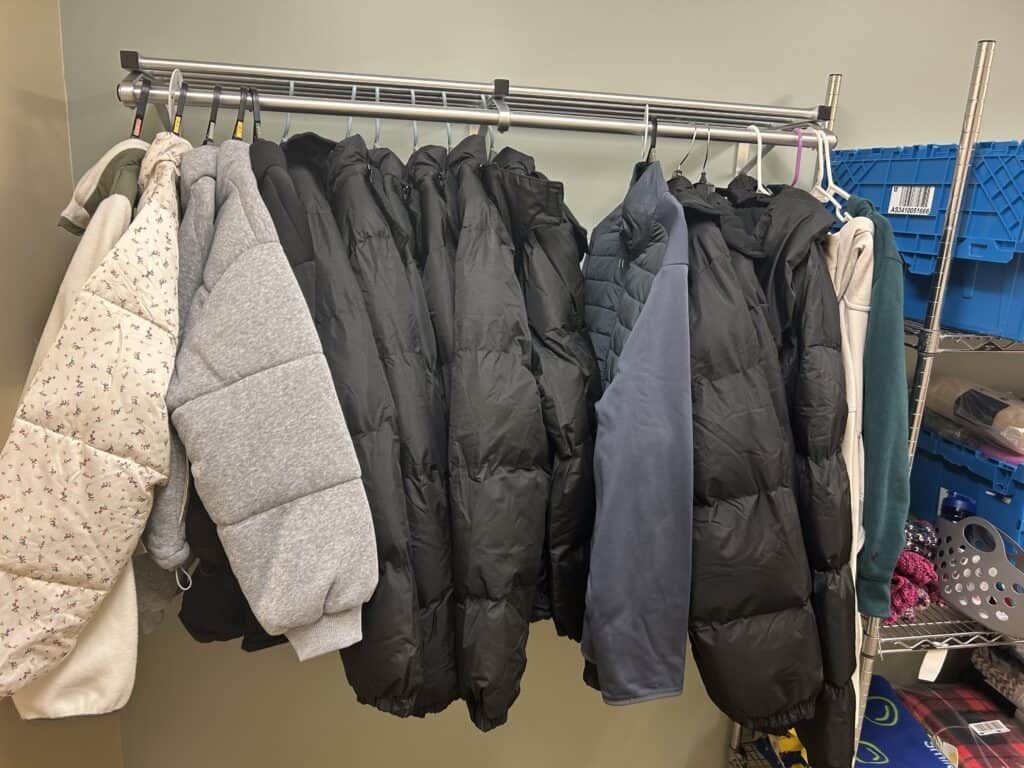 Coats on a rack inside the closet