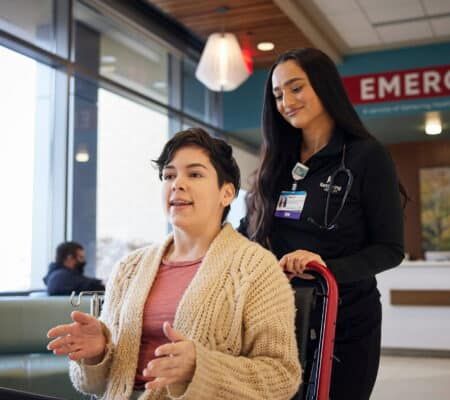 Healthcare provider assisting patient at hospital reception desk, illustrating compassionate addiction recovery care.