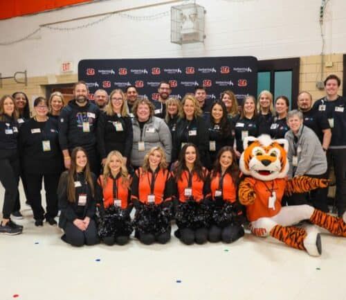 Volunteers standing and smiling