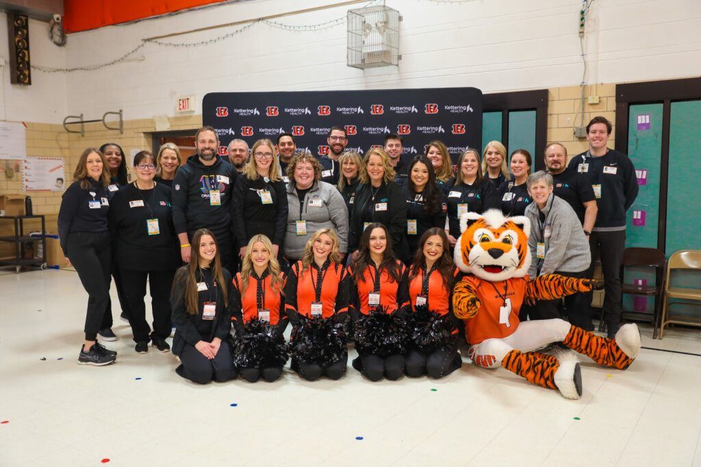 Volunteers standing and smiling