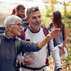Woman giving direction to a man while hiking