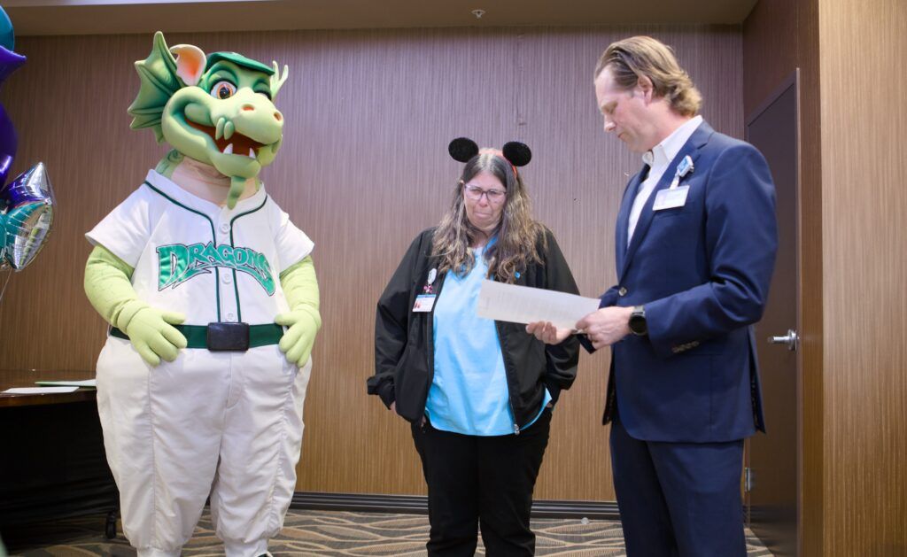 Paul Hoover presenting Robin Kehl with the Disney trip