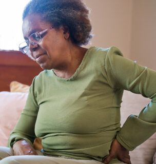 Woman holding her back and hip in pain