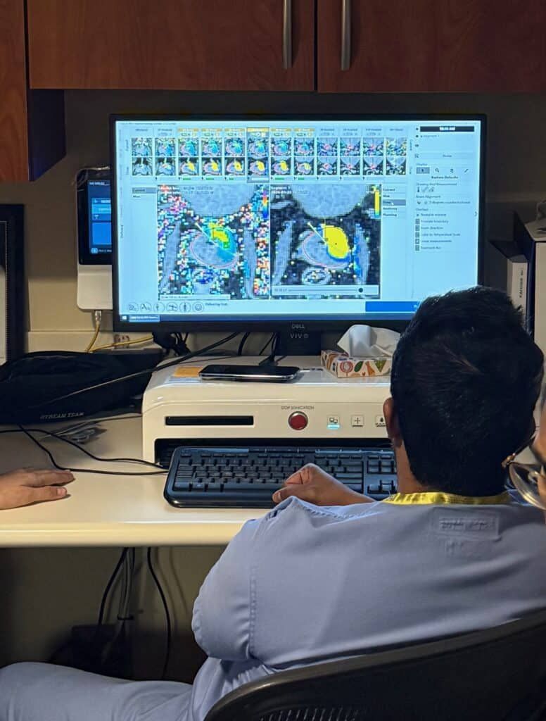 Dr. Pucheril sitting in front of the computer looking at a scan