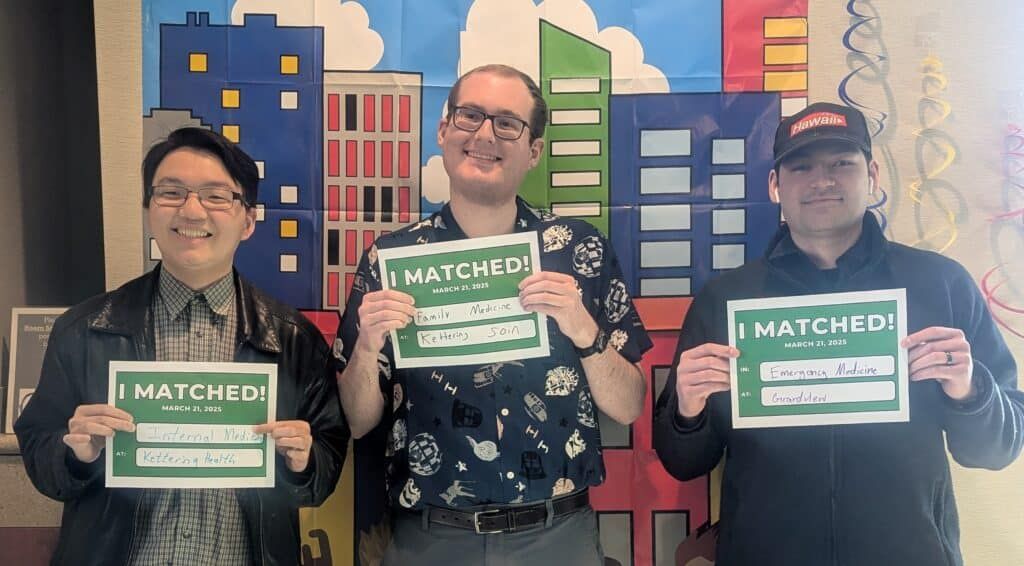 Students holding up "I matched" signs