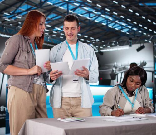 People gathered around looking at papers