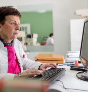 Doctor typing on computer