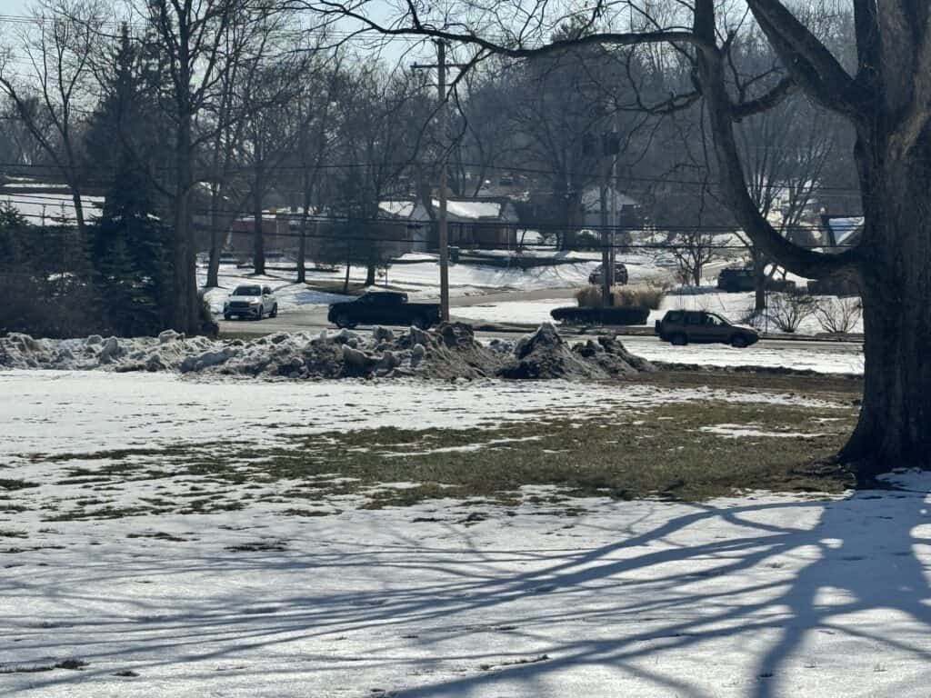Snow on the ground near a parking lot