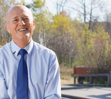 Harold Niehaus smiling outside in front of a park