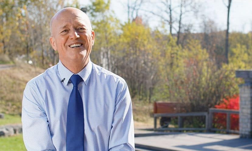 Harold Niehaus smiling outside in front of a park
