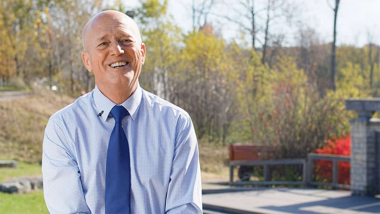 Harold Niehaus smiling outside in front of a park