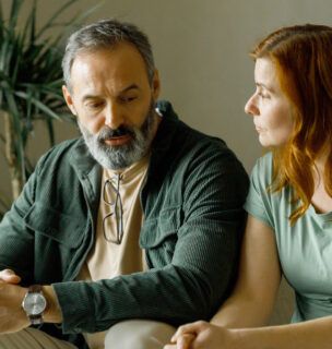 Man talking to a woman inside