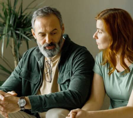 Man talking to a woman inside