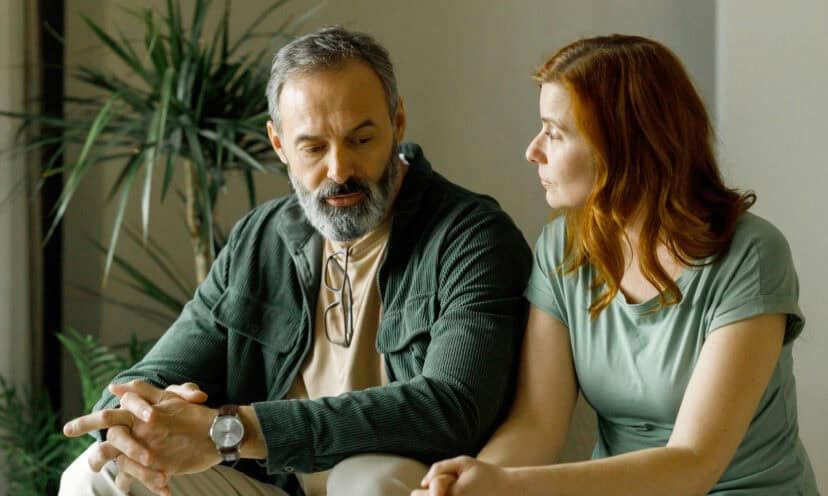 Man talking to a woman inside