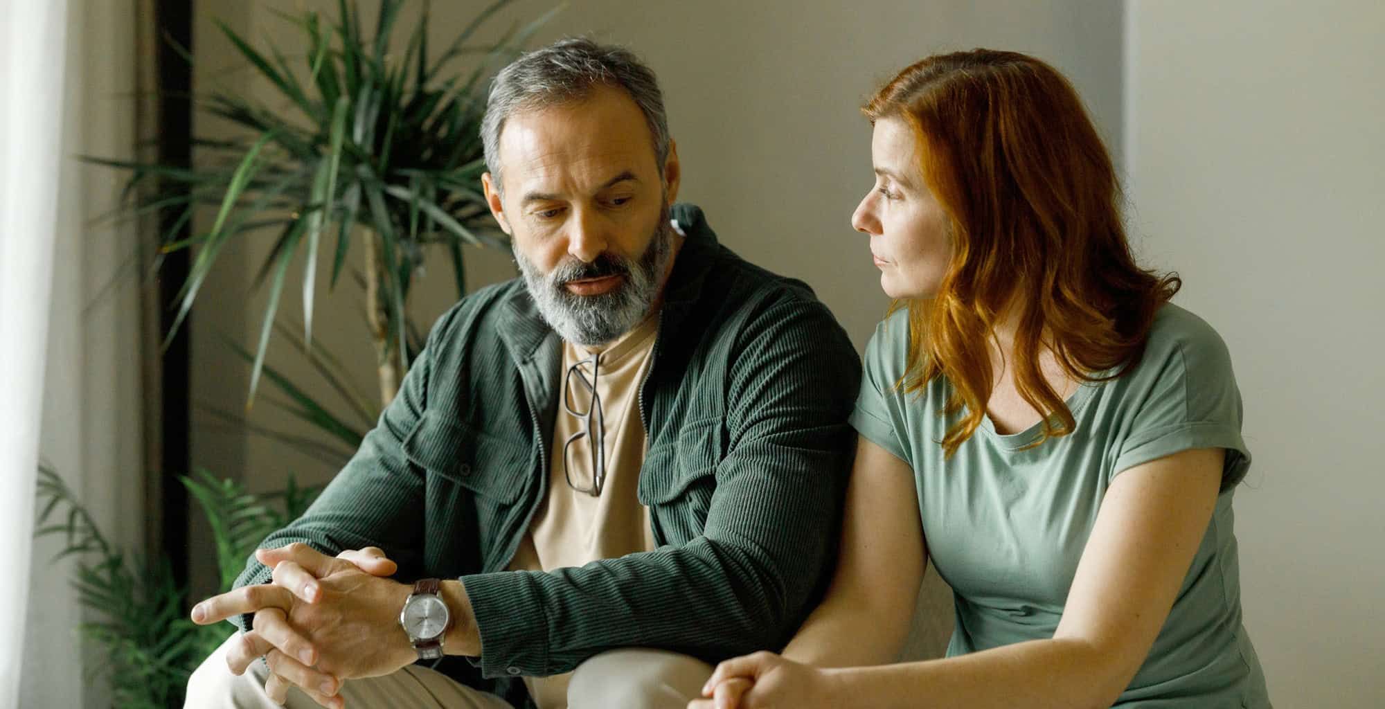 Man talking to a woman inside