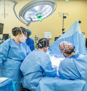 Doctors surrounding a patient on a surgery table