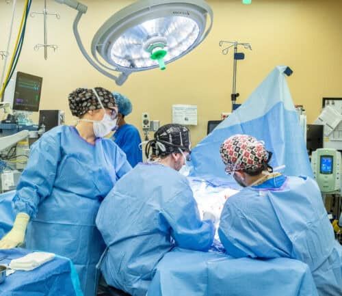 Doctors surrounding a patient on a surgery table