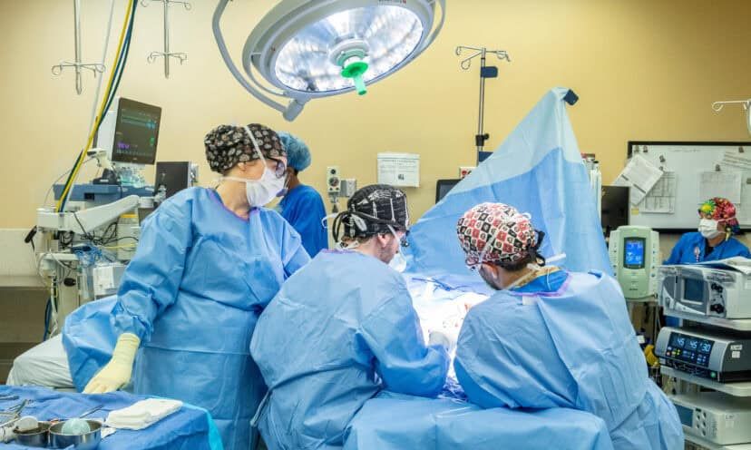 Doctors surrounding a patient on a surgery table