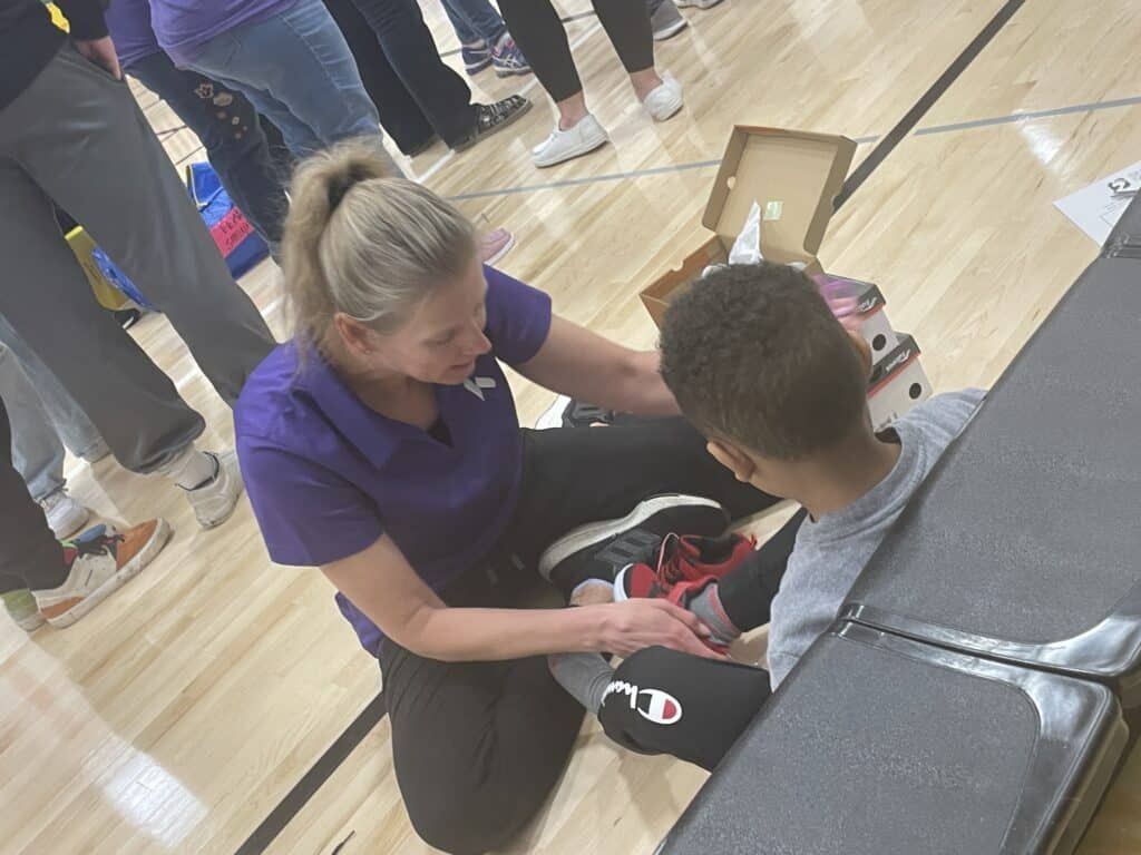 Kettering Health’s Therapy and Sports Medicine team volunteers with Shoes 4 the Shoeless.