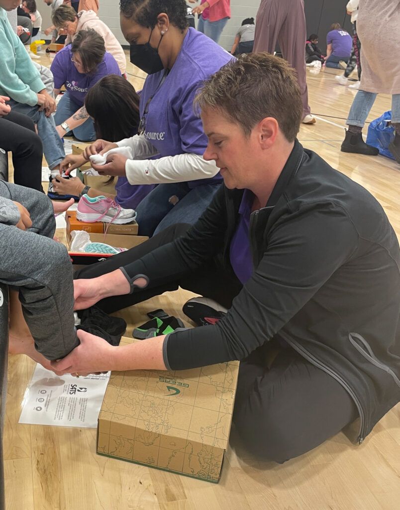 Kettering Health’s Therapy and Sports Medicine team volunteers with Shoes 4 the Shoeless.