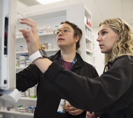 College student with professor in pharmacy studies. She are learning to become health care professionals. Horizontal waist up indoors shot with copy space. This was taken in Quebec, Canada.
