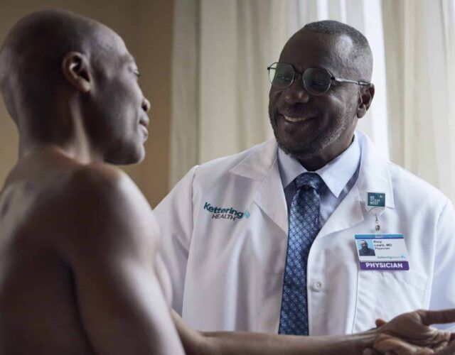 Dr. Lewis examining a patients shoulder