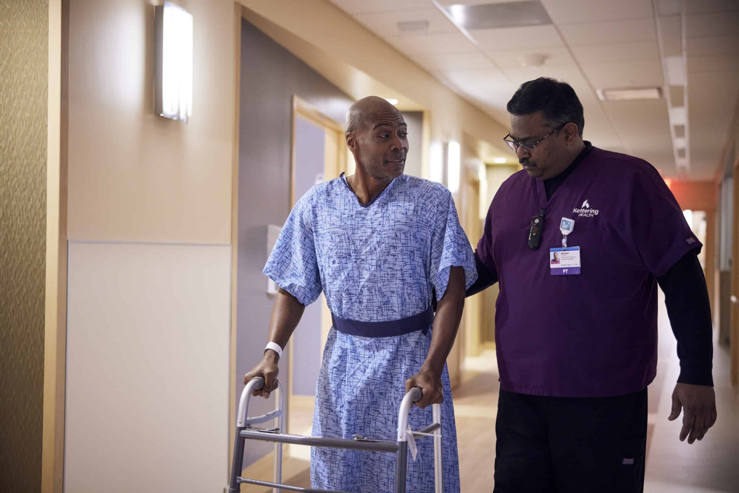 Patient walking with nurse and walker