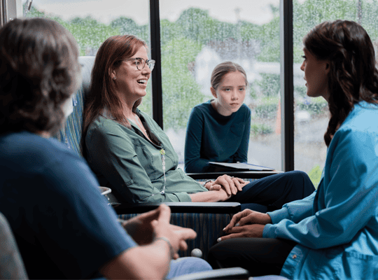 Oncology patient talking with their doctor and family