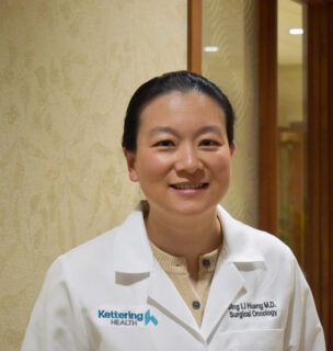 Dr. Jing Li Huang smiles for a photo.