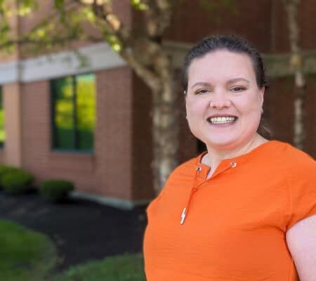 Dr. Kali Hollingsworth, Sports Medicine Fellowship Director, smiling for a photo outside a building