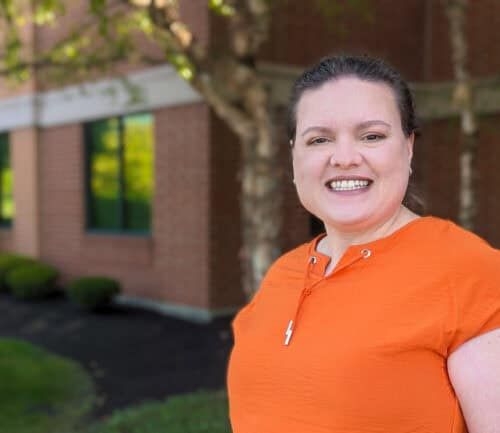 Dr. Kali Hollingsworth, Sports Medicine Fellowship Director, smiling for a photo outside a building