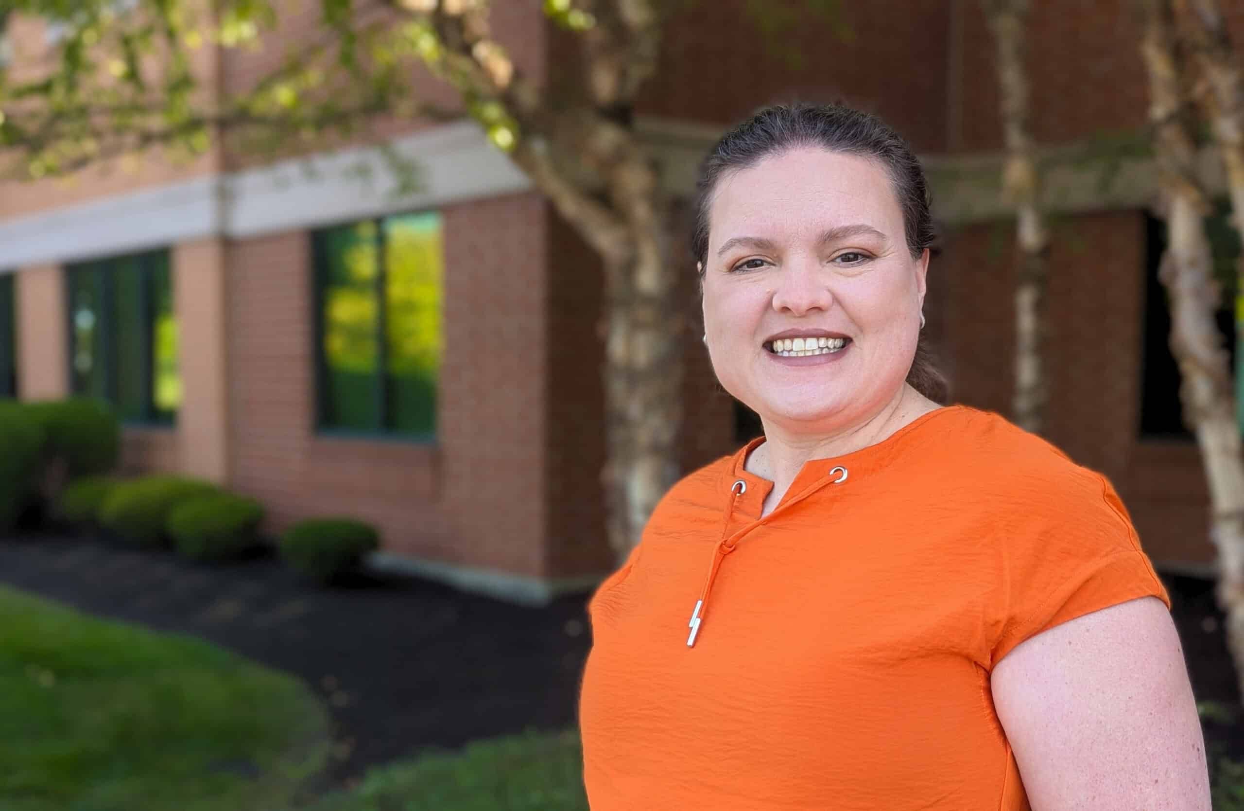 Dr. Kali Hollingsworth, Sports Medicine Fellowship Director, smiling for a photo outside a building