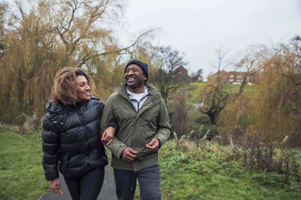 Man and Woman walking outside in the fall in warm clothing