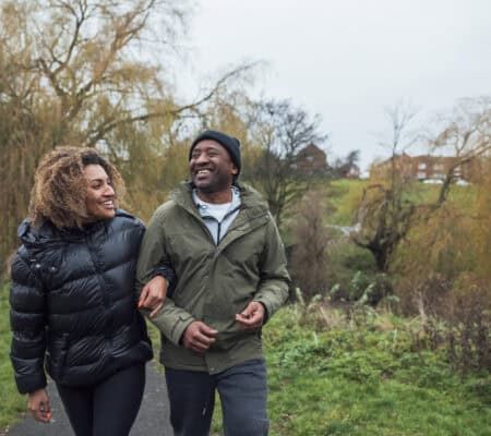Man and Woman walking outside in the fall in warm clothing