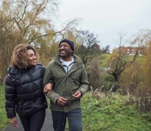 Man and Woman walking outside in the fall in warm clothing