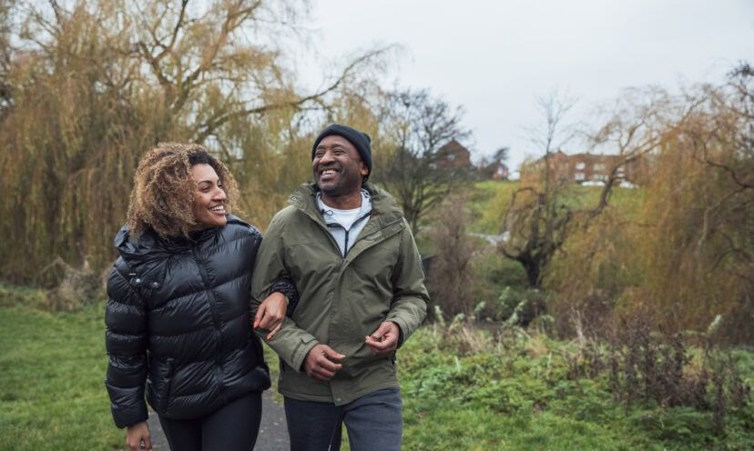 Man and Woman walking outside in the fall in warm clothing
