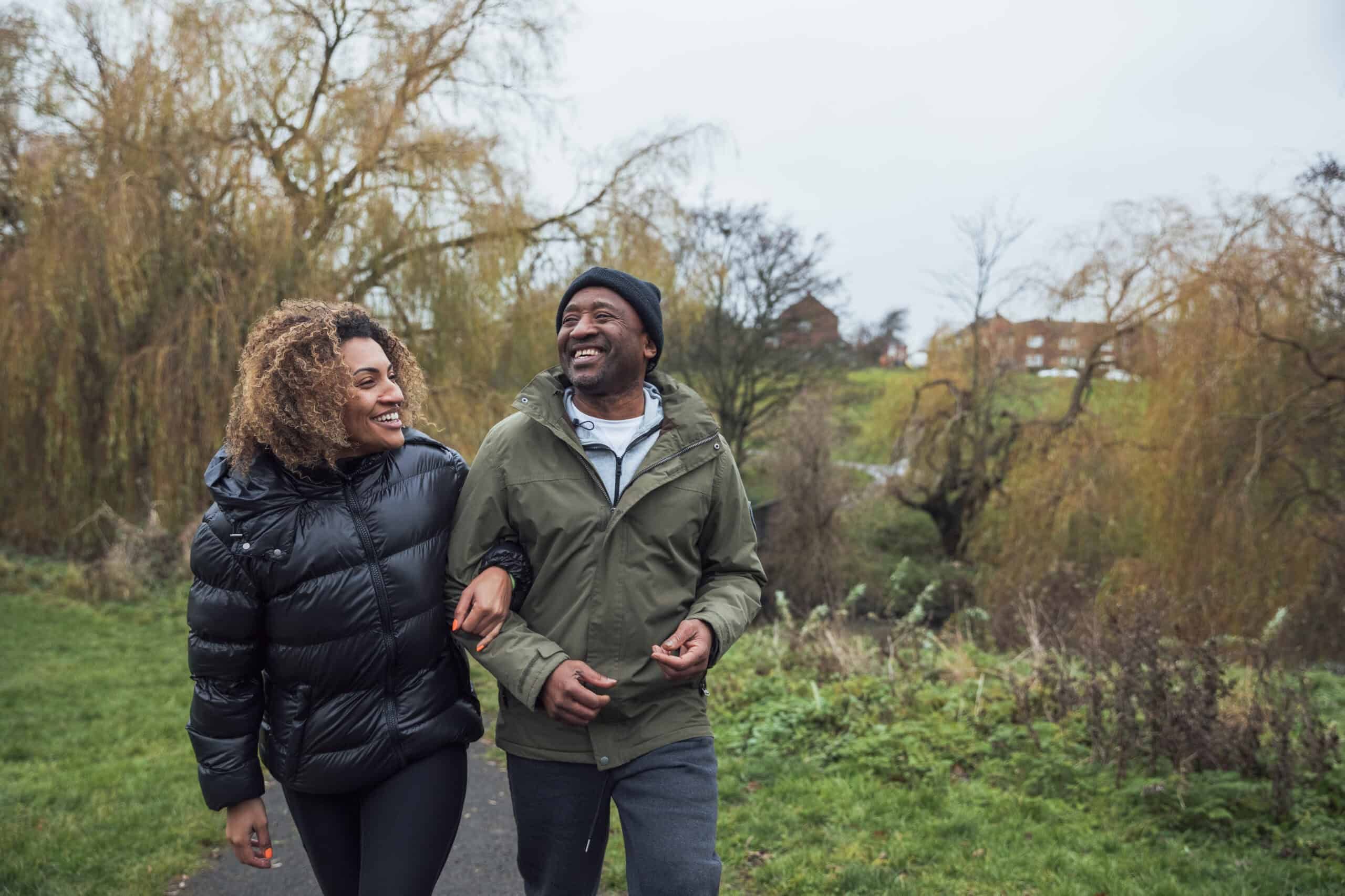 Man and Woman walking outside in the fall in warm clothing